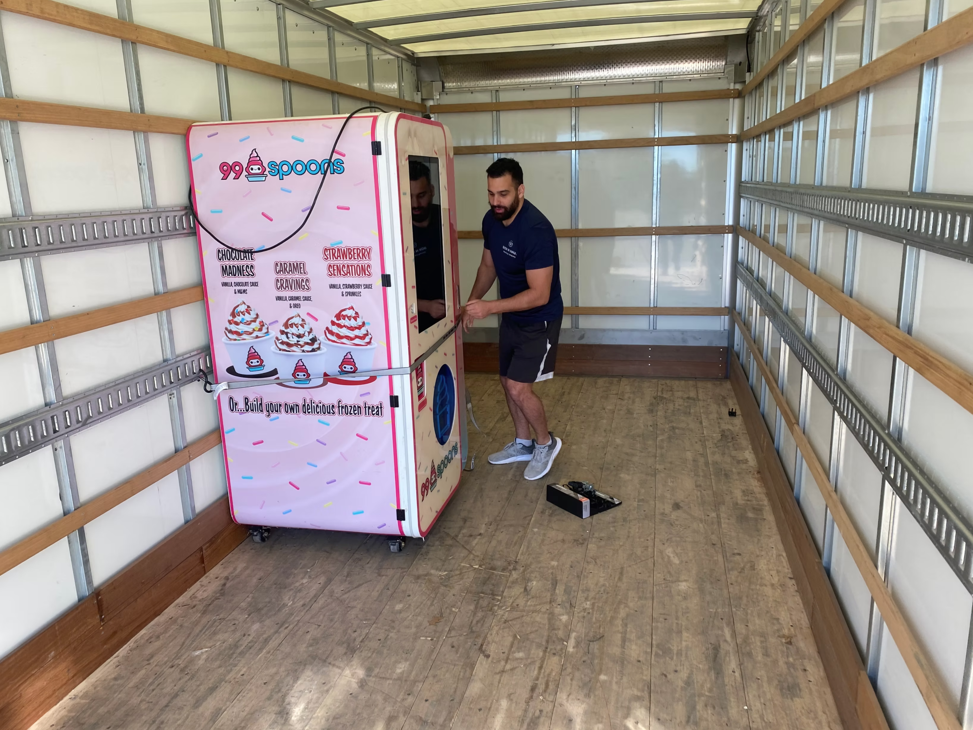 Box N Haul mover securing a 99 Spoons frozen-treat vending machine inside the moving truck.