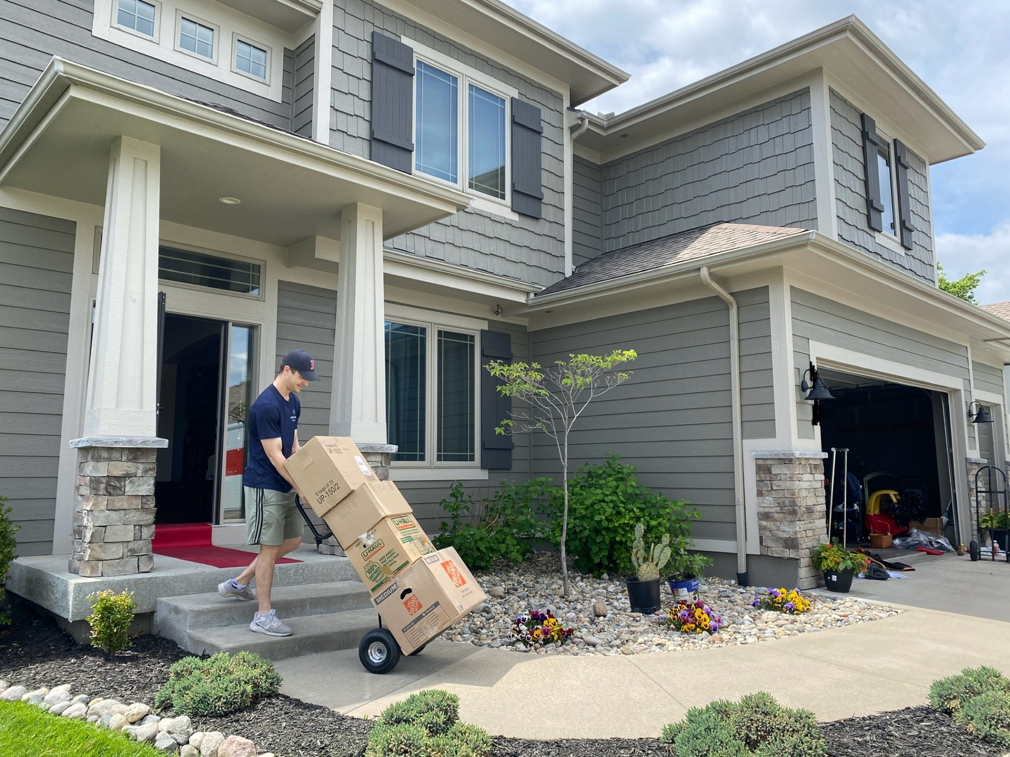 Box N Haul mover unloading boxes at a home